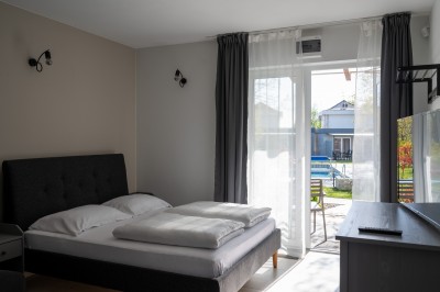 Zdjęcie przedstawia łóżko w pokoju - MEDUSA apartamenty i bungalowy | Niechorze (wypoczywaj nad morzem) 