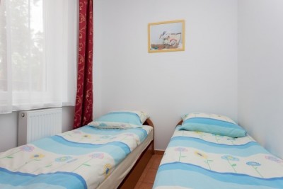 Łóżko w pokoju - pensjonat POD FILARAMI